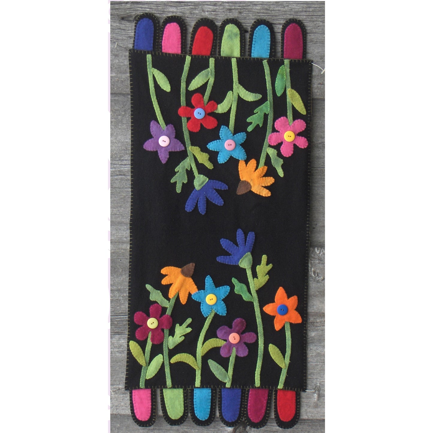 Colorful table runner with a floral design on a black background