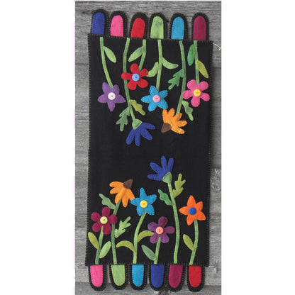Colorful table runner with a floral design on a black background