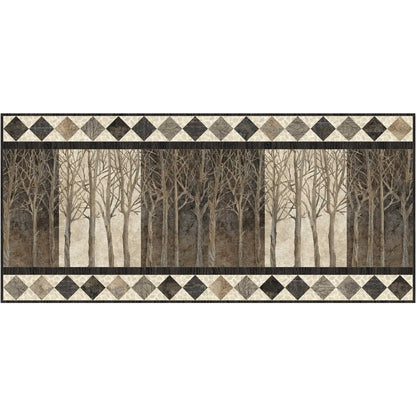 Quilted bed runner with forest design and diamond pattern border on a white background.
