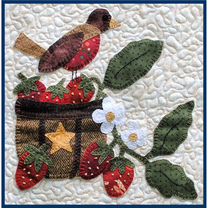 Quilt block with a bird, strawberries, and flowers on a textured white background