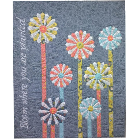  7 Dresden Star flower blooms on applique stems adorn this wall hanging. Bloom where you are planted is applique up the left hand side.